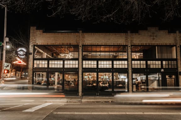 a night view of the front of the building  at The Hemlock, Washington, 98103