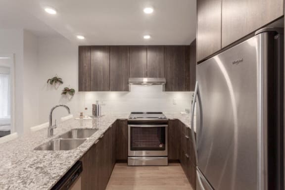 a kitchen with stainless steel appliances and granite counter tops