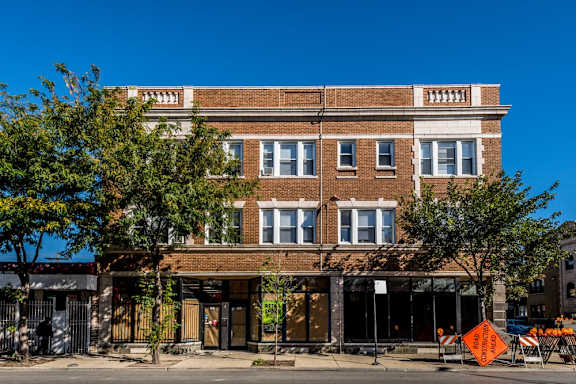 an old brick building on the side of a street