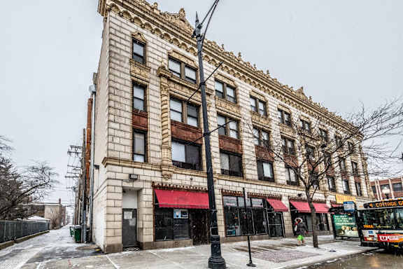a building on a city street with a bus