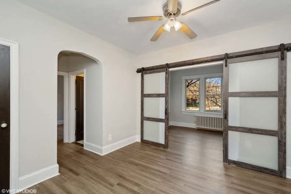 a bedroom with a ceiling fan and a window