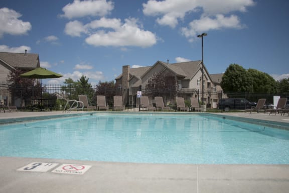 Community pool with lounge chairs at Stone Ridge Estates