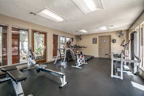 Gym with cardio equipment and strength training machines at The Colony Apartments, Universal City