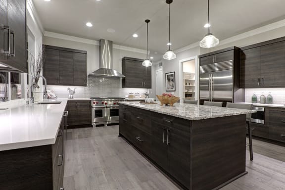a large kitchen with a large island and stainless steel appliances
