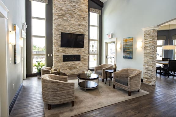 a living room with couches and chairs and a fireplace