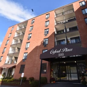 a red brick building with a black awning and the word glen place