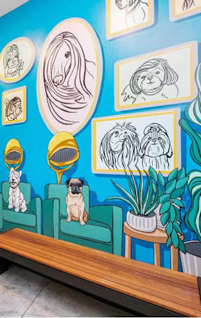 A mural of dogs in various poses and expressions is displayed on a wall.