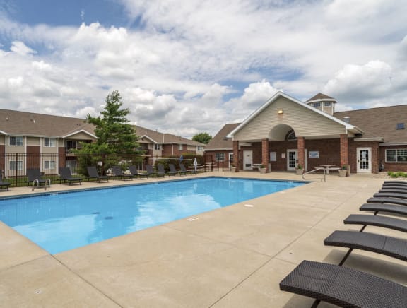 Large outdoor pool with lounge chairs at The Northbrook Apartments