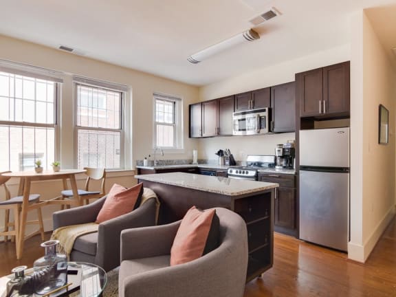a kitchen and living room in a 555 waverly unit at 1841 Columbia Road Apartments, Washington, Washington DC