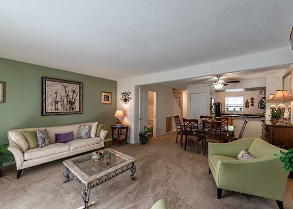 A living room with a couch, chairs, and a coffee table.
