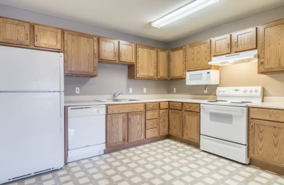Kitchen with white appliances and lots of cabinet storage at Northridge Heights in north Lincoln