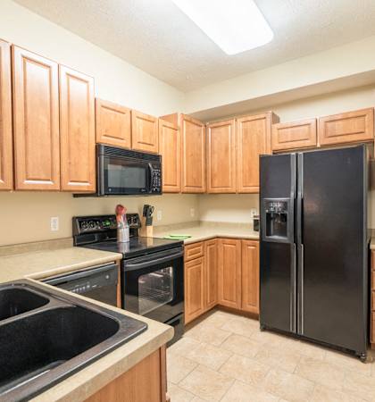 Interiors-Kitchen with side-by-side fridge at Ridge Pointe Villas townhomes