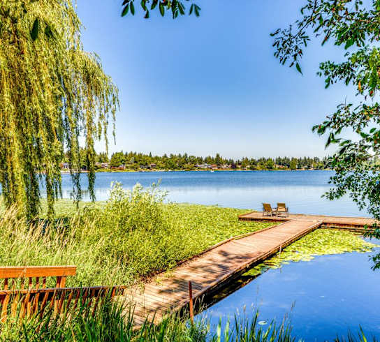 a dock on a lake with a bench