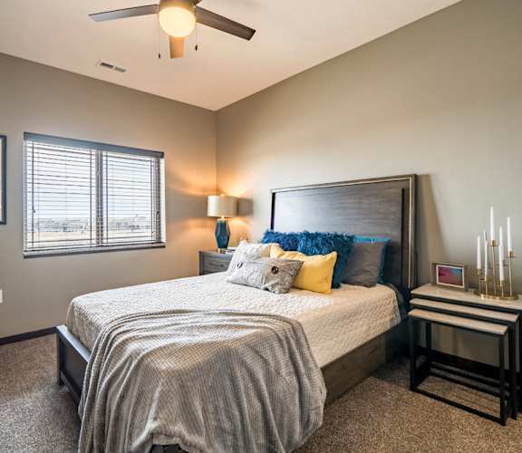 Bedroom with ceiling fan and natural lighting at 360 at Jordan West best new apartments West Des Moines IA 50266