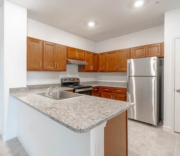 a kitchen with a granite counter top and stainless steel appliances