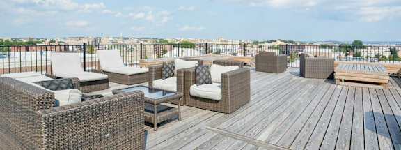 a rooftop deck with lounge chairs and a fire pit at 1841 Columbia Road Apartments, Washington, Washington DC