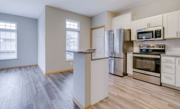 Kitchen with stainless steel appliances and island at Cascade Pines duplex and townhomes
