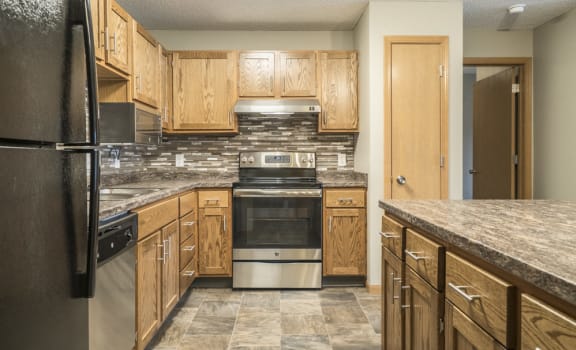Interiors-Renovated kitchen with tile backsplash and new appliances at Highland View