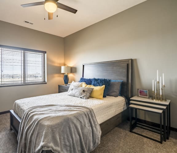 Bedroom with ceiling fan and natural lighting at 360 at Jordan West best new apartments West Des Moines IA 50266