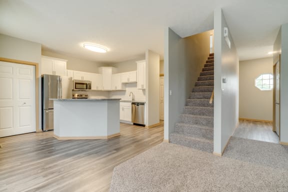Living and dinning room area with view of kitchen and stairs to the second floor at Cascade Pines Duplex and Townhomes