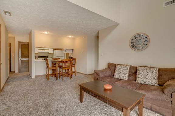Living room in loft style apartment with view into the kitchen off of dining area