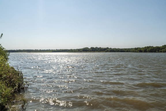 the sun reflecting off the water on a lake