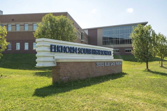 a sign for Elkhorn South High School in front of a building