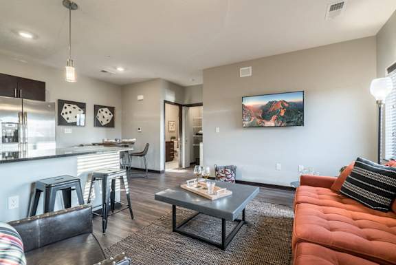 Modern and inviting open layout of living room and kitchen at The Villas at Mahoney Park