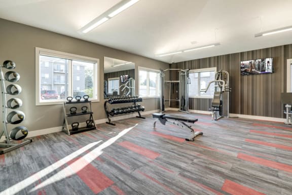 Strength training machines and free weights in the fitness center at Highland View