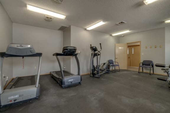 Two treadmills and an elliptical in the fitness center at Skyline View
