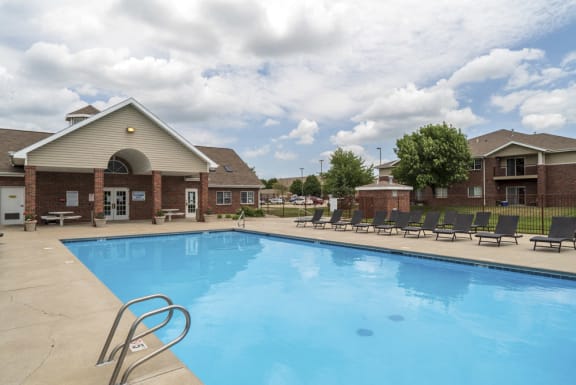 Large outdoor pool with lounge chairs at The Northbrook Apartments in Lincoln, NE