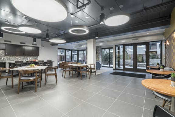 Dimly lit lounge with seating areas and kitchen