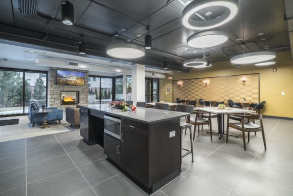 Kitchen area looking into multiple seating areas in the clubhouse at The Conrad