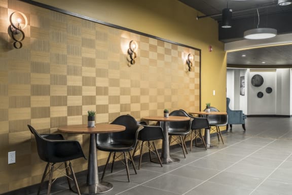 Dimly lit lounge with seating areas and checkered wall