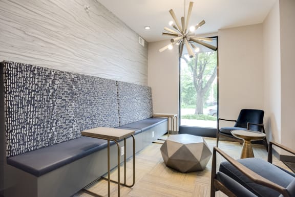 Lounge room with built in seating against the wall and individual seating areas