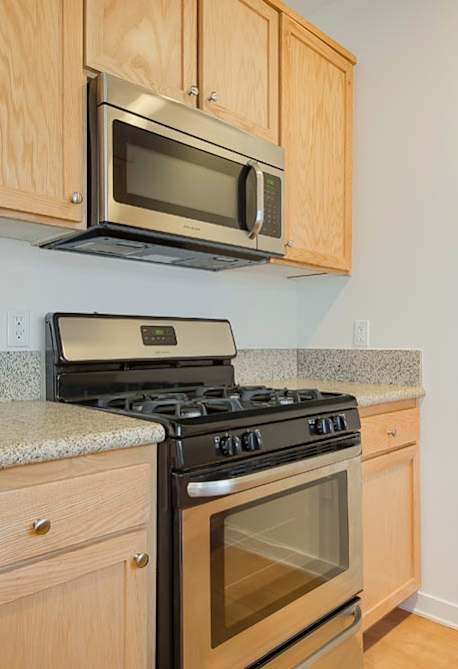 A kitchen with a refrigerator, microwave, oven, and sink at Valley Street Apartment, Los Angeles, CA, 90057