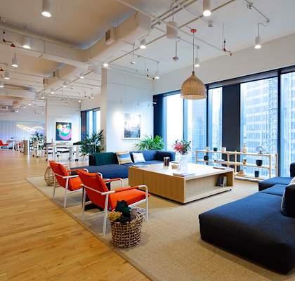 a large living room with large windows and furniture