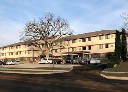 A large building with a parking lot in front of it.