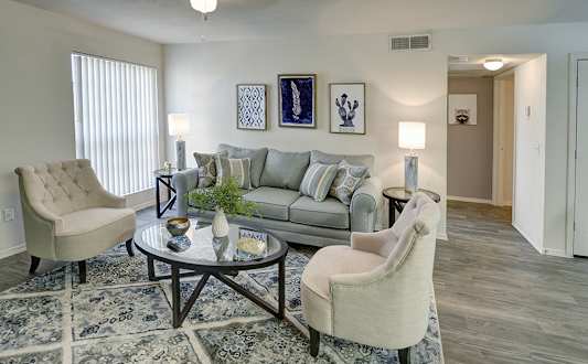 A living room with a grey couch, two chairs and a coffee table.at Cottonwood Crossing, Casa Grande, AZ 85122