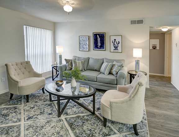 A living room with a grey couch, two chairs and a coffee table.at Cottonwood Crossing, Casa Grande, 85122