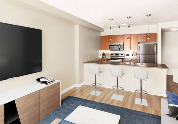 open concept kitchen with 3 stools, a fridge, stove and microwave
