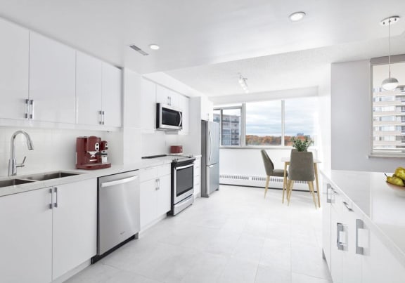 Modern suite kitchen with stainless steel appliances and quartz countertops