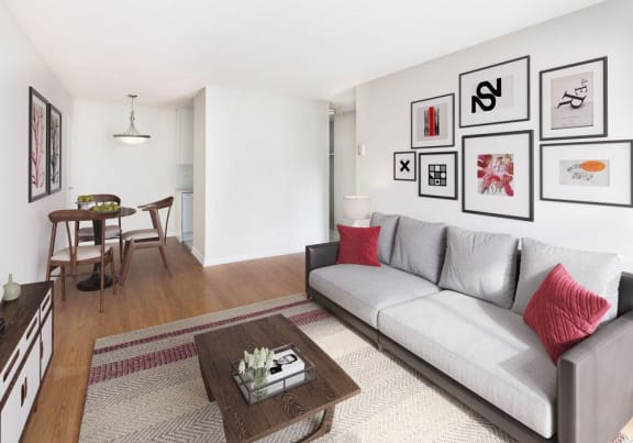 Livingroom with a sofa, table, area rug and pictures on the wall