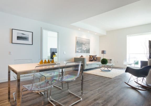 a living room with a glass table and chairs