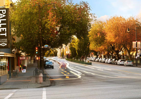 a busy city street with cars driving down it