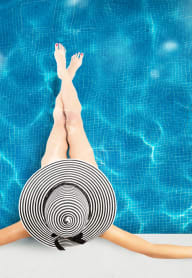 a woman laying on her back in a pool with her arms up in the air at Regatta at New River, Fort Lauderdale, FL