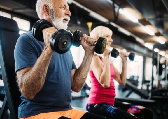 a man and a woman lifting weights in a gym at Loma Linda Springs, Loma Linda, CA, 92354