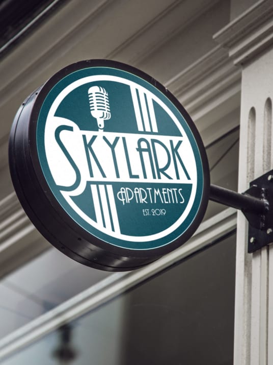 a sign for skylark apartments on the side of a building at Skylark, Savannah, GA
