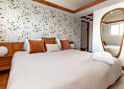 Thumbnail 16 of 18 - a bedroom with a large bed and a mirror at 8535 Colgate-Fully Furnished Apartments, Los Angeles