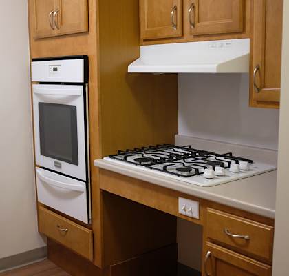 a small kitchen with a stove and a microwave